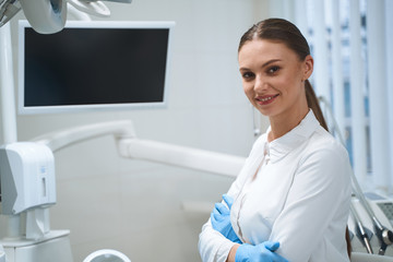 Cheerful dentist in modern office stock photo