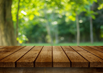 empty wooden table on green background
