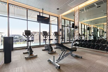Papier Peint photo Fitness Equipment in modern gyms fitness with city and sky view