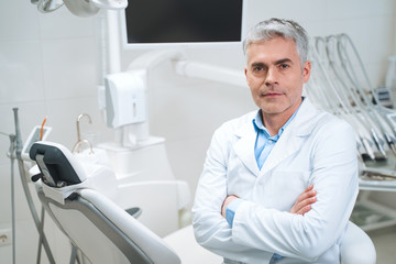 Obraz premium Mature dentist in his office stock photo