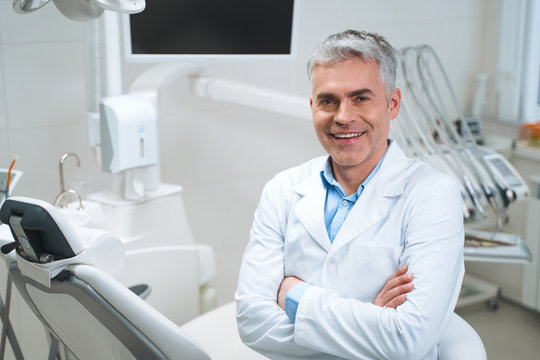 Cheerful dentist in his office stock photo