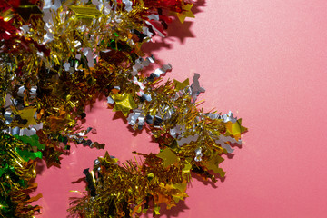Tinsel decorations for christmas,  on pink background with clipping path and copy space.