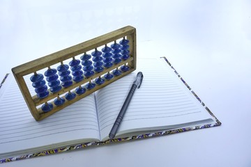 Wallpaper with an educational concept with paper drawings, pens and abacus
