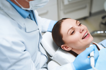 Smiling young lady in dental clinic stock photo