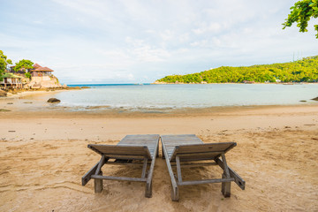 Fototapeta premium Empty beach chair white sand with coconut palm tree paradise sea