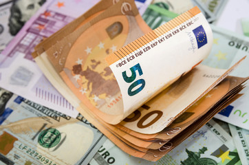50 euros on dollars and euro banknotes. Money background. Much money.