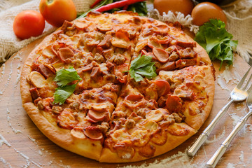 Pizza on rustic grey background, top view. Pizza with minched meat, celery and Mozzarella Cheese close up.