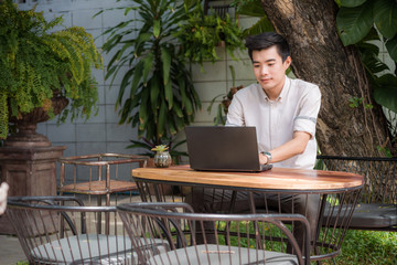 Busines man use laptop in garden