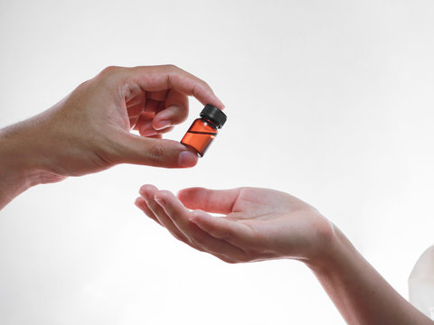 Focus on male hand giving liquid medicine bottle to the patient, corona virus or Covid-19 Vaccine, Medicine and healthcare concept