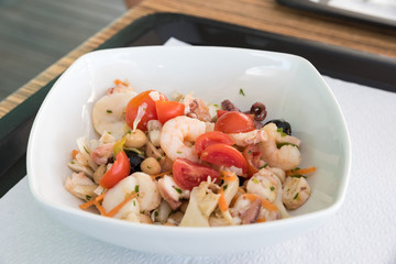Fish salad with tomatoes and olives