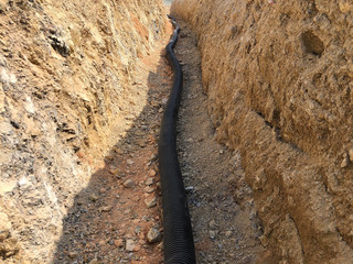 The high voltage electrical cable is laid in a trench