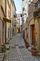 Fototapeta na wymiar Guardia Sanframondi, Italy, 04/30/2018. A narrow street among the small houses of a medieval village in the Campania region