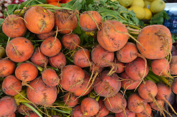 Fresh orange organic beetroots in display for sale at a street food market, side view or flat lay photo of healthy food photographed at the Market Hall in Gothenburg, Sweden

