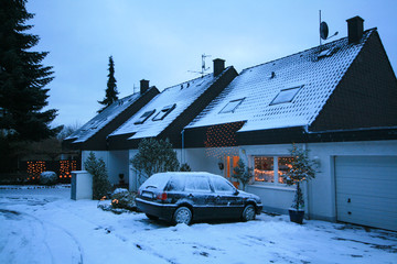 Snow covered house and car