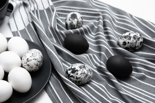 Stylish black and white eggs in a plate for advertising, interior design, billboards and paintings.
