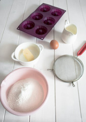 baking ingredients lie on a white wooden table