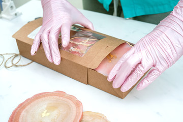 Creativity and craft. Resin coasters and packaging for them. Gift wrapping. Decorative packaging. Idea for business. Remote work, work at home. Art coasters.