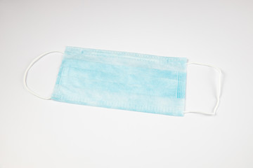 Fototapeta premium Antiviral medical mask for protection against coronavirus COVID-19. Medical protective mask on white background. Disposable surgical face mask cover the mouth and nose. Healthcare and medical concept.