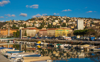 The waterfront harbour area of Rijeka in the Primorje-Gorski Kotar county of Croatia. Trsat castle can be seen background left, and the Bridge of Croatian Defenders from The Homeland War central left
