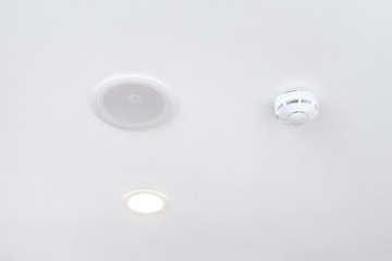Built-in ceiling speaker and fire alarm sensor. The concept of security in the building.