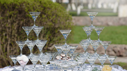 Champagne pyramid at a wedding on the nature. Welcome Drink for guests