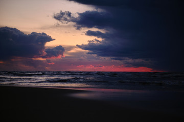 Fototapeta na wymiar Dark cloudy sunset over the sea
