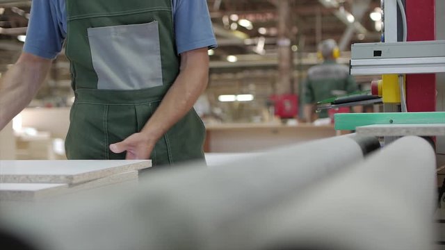 Factory worker inspects MDF wood parts Mittel Dichte Fazerplatte