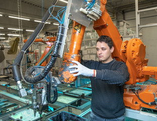 preparing a robot for the production of a new type of cars in the automotive industry