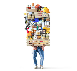 Man is holding a huge pile of food and other goods