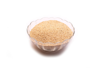 Poppy seeds in glass pot on white background