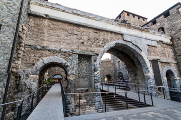 stone arch of Porta Praetoria in Aosta, ancient city gate. Aosta Valley, Italy