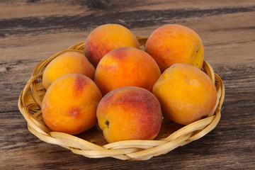 Peach heap in the wooden basket