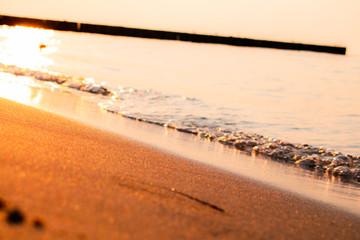 sunset or dawn of the sun on the sea or ocean, waves and sea sand