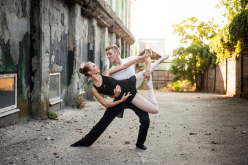 girl and guy dancers perform a passionate dance together outdoors in nature