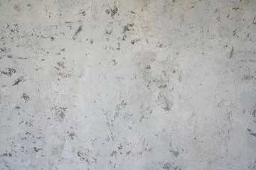 Light grey cement wall with random grunge textures on surface.  Renovation, decoration ideas for background and building objects.