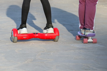 Teens riding gyrometer and skateboard closeup