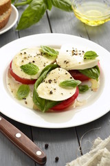 Caprese salad of tomato, mozzarella, basil. Italian food, vertical