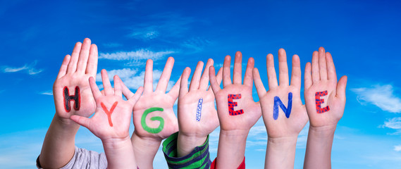 Kids Hands Holding Colorful English Word Hygiene. Blue Sky As Background - obrazy, fototapety, plakaty
