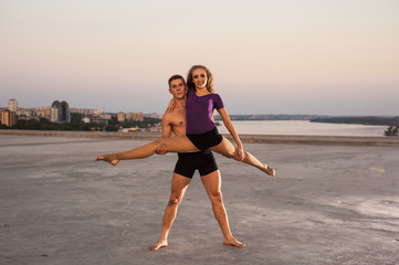 girl and guy dancers perform a passionate dance together outdoors in nature