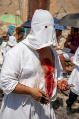 hooded men (battenti) beat their chest with a sponge with a nail, losing blood during septennial rites of penance, rituals in honor of Our Lady in Guardia Sanframondi, Benevento, Italy