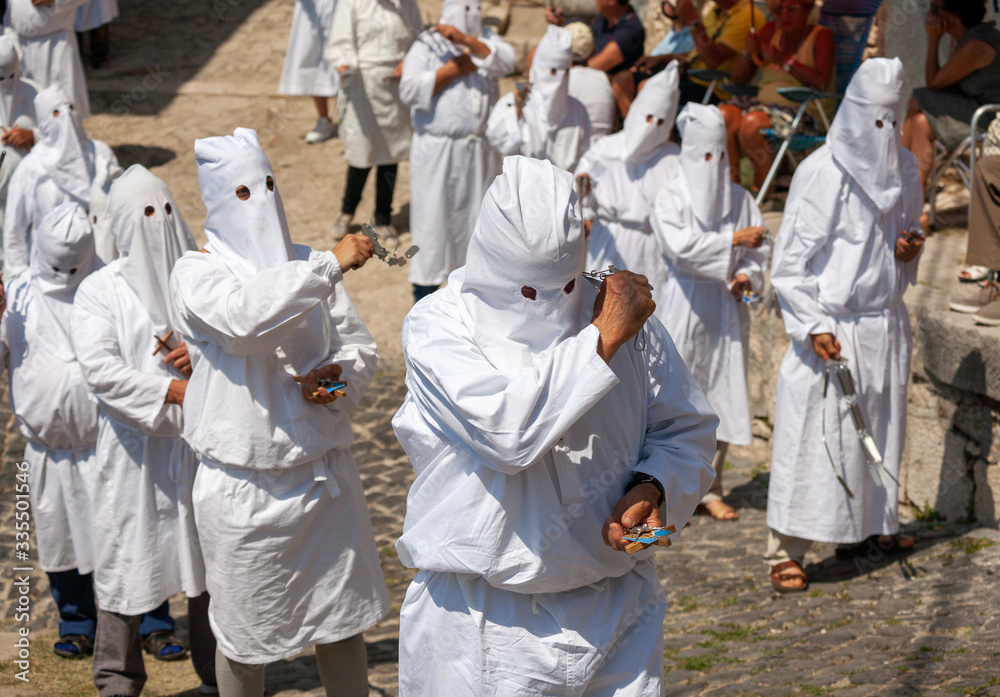 Wall mural hooded men (battenti) beat their chest with a sponge with a nail, losing blood during septennial rit