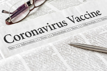 A newspaper with the headline Coronavirus Vaccine