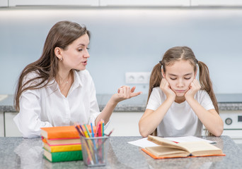 Mom scolds sad daughter for poor schooling. Family relationships