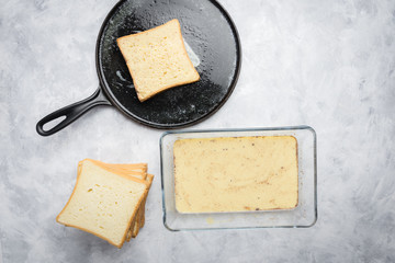 Ingredients and preparation of delicious sweet French toast with cinnamon and vanilla. Quick and easy breakfast, top view