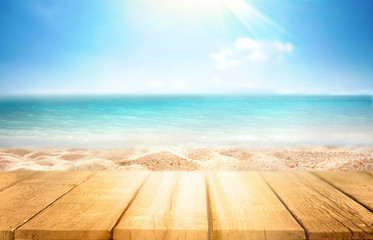 tropical summer beach with empty wooden flooring in rays of sun light on nature. Golden sand beach,...