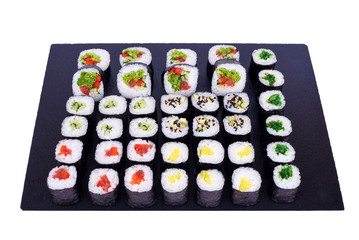 Maki Sushi set Yasai rolls with fresh ingredients. Rolls on black stone isolated on white background. Sushi menu. Japanese food.