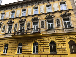 Yellow building facade in romanesque style