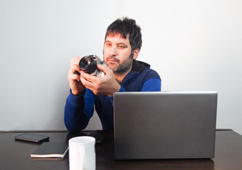 Male photographer working at home. Concept: work at home, freelance