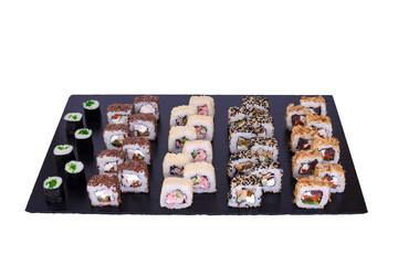 sushi set Yakito rolls with fresh ingredients on black stone isolated on white background. Sushi menu. Japanese food.