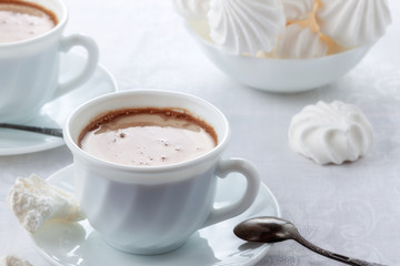 A cup of fresh coffee with cream and a gentle, airy Bizet